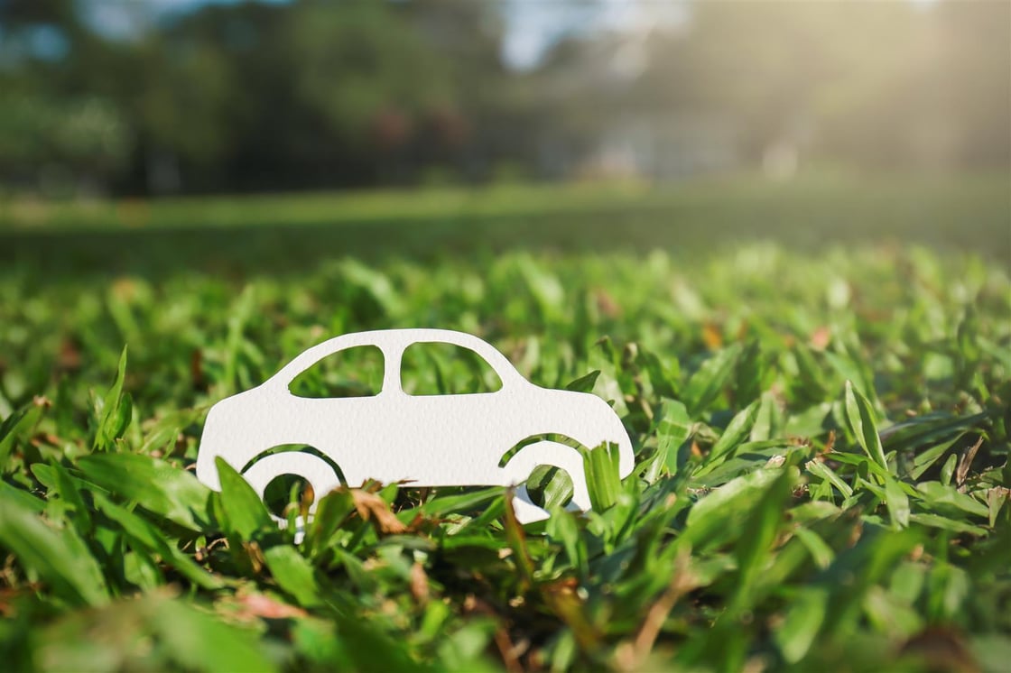 bigstock-Paper-Cut-Of-Car-On-Green-Gras-264849895